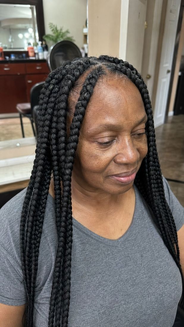 Black woman over 60 with lightweight jumbo box braids