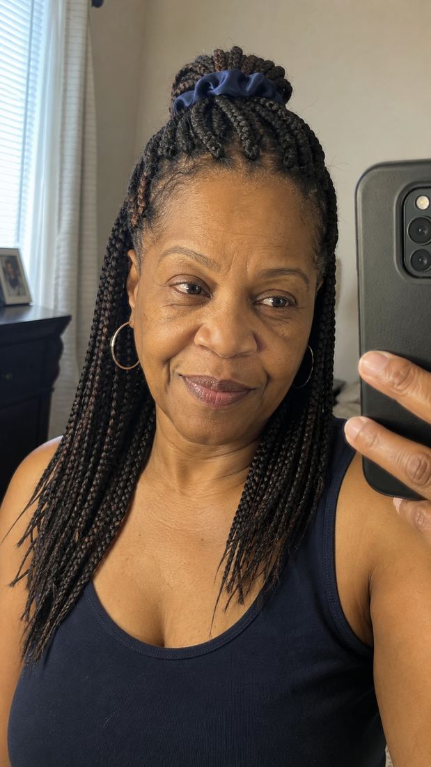 Black woman over 50 with half-up half-down medium box braids
