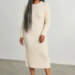 Black woman over 50 wearing loose waist-length gray box braids with medium parts and soft edges