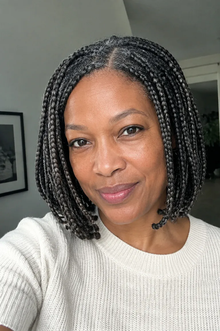 Older Black woman with chin-length box braids and a neat lightweight finish