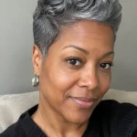 Black woman over 50 with a classic tapered pixie cut in gray hair
