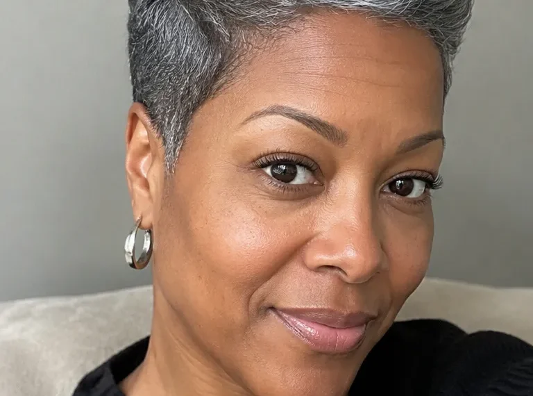 Black woman over 50 with a classic tapered pixie cut in gray hair