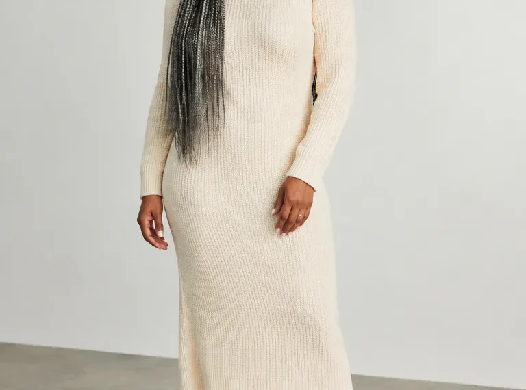 Black woman over 50 wearing loose waist-length gray box braids with medium parts and soft edges
