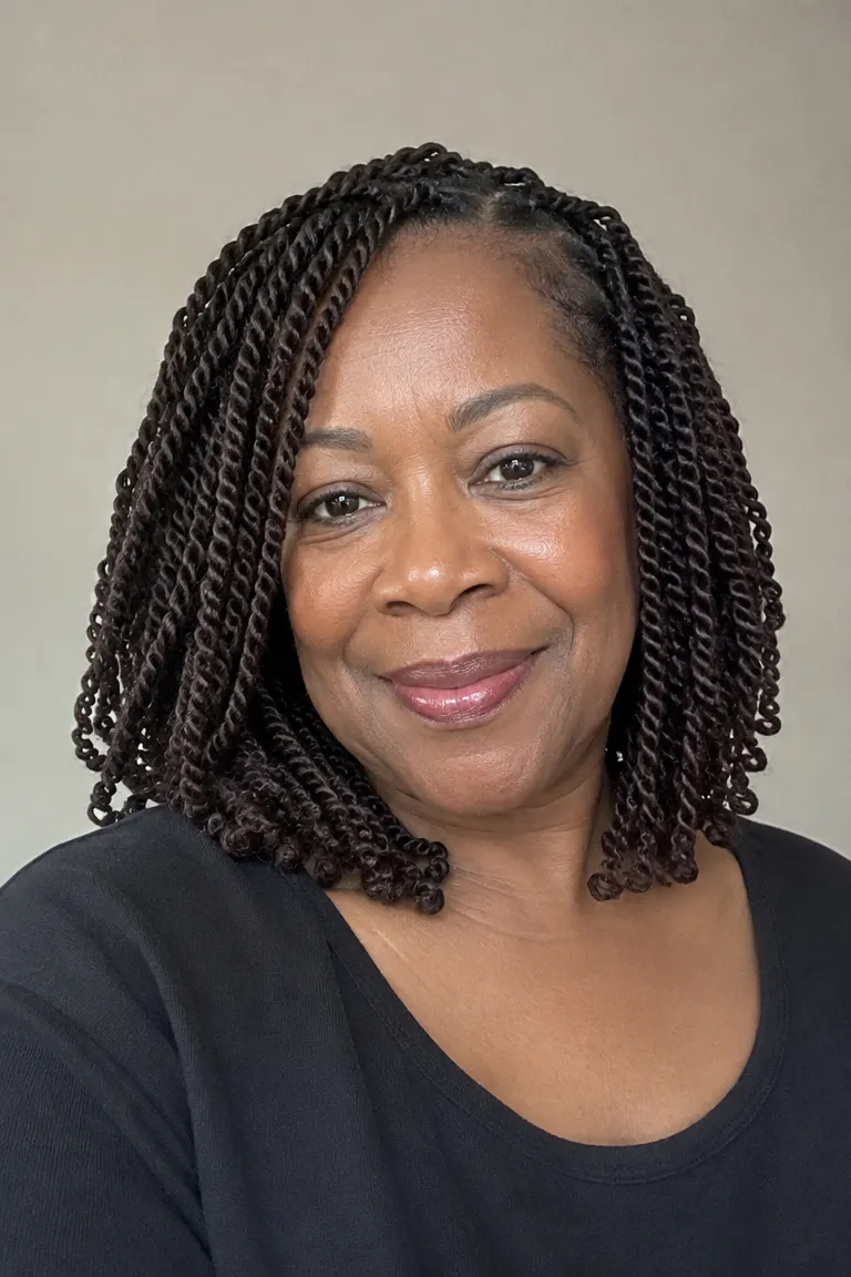 Soft medium crochet twists reaching the collarbone on a Black woman over 60