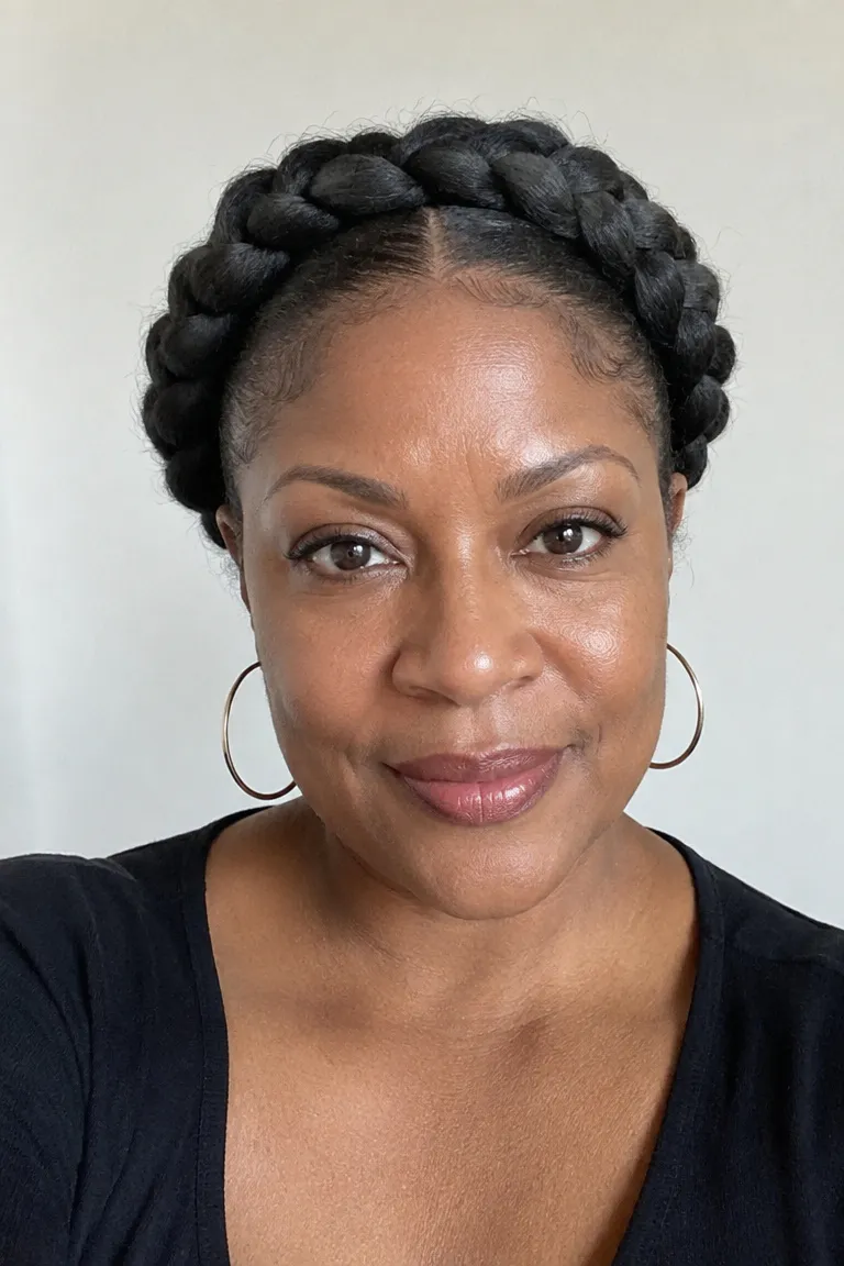 Black woman over 50 wearing a halo braid crown