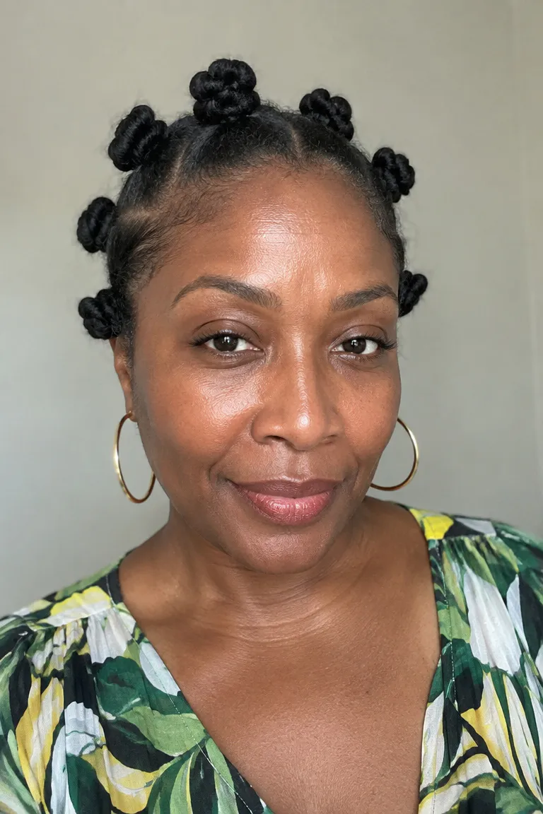 Older Black woman with short natural Bantu knots