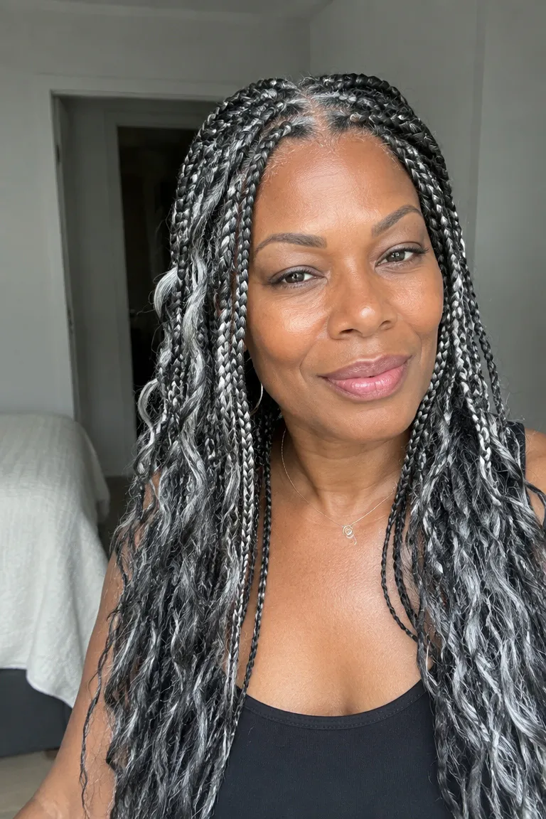 Older Black woman wearing gray blend braids with a soft, polished look