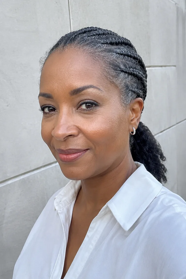 Older Black woman with a short feed-in ponytail that looks neat and light