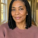 Shoulder-length knotless box braids with medium sections and clean center parts