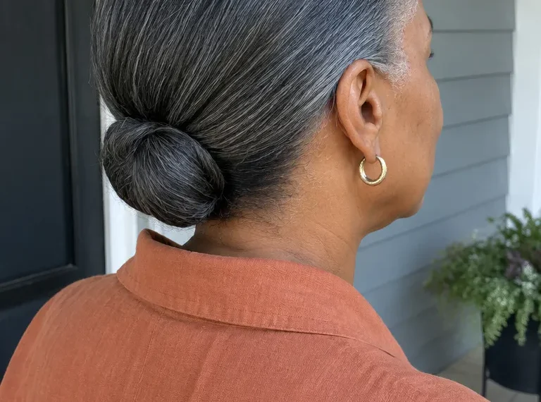 Low tucked bun with smooth sides and tucked ends
